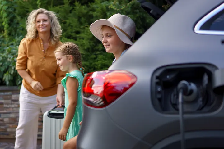 kids and parent enjoying at vacation rental area while xova charger charging their ev