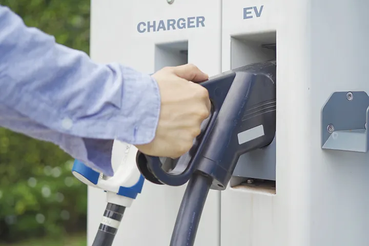 a person charging his EV at his workplace